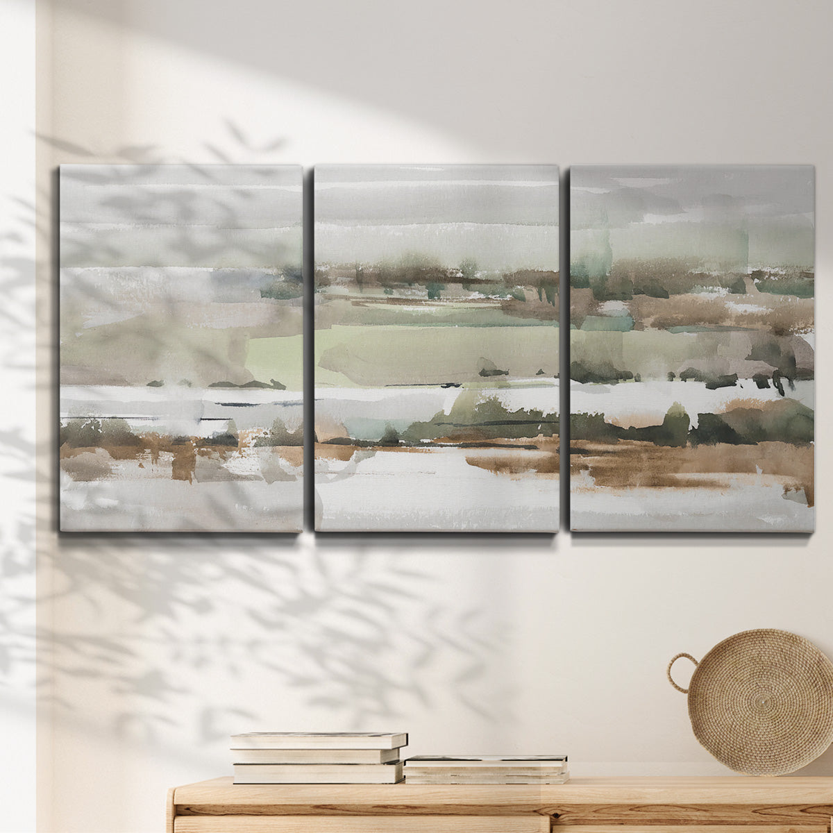 Three-panel canvas wall art featuring layered turquoise and earth tones abstract, displayed in a minimalist living room above a console table.