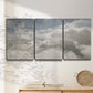Three-panel canvas wall art featuring aerial landscape view photograph, displayed in a minimalist living room above a console table.