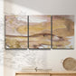 Three-panel canvas wall art featuring layered abstract dawn tones, displayed in a minimalist living room above a console table.