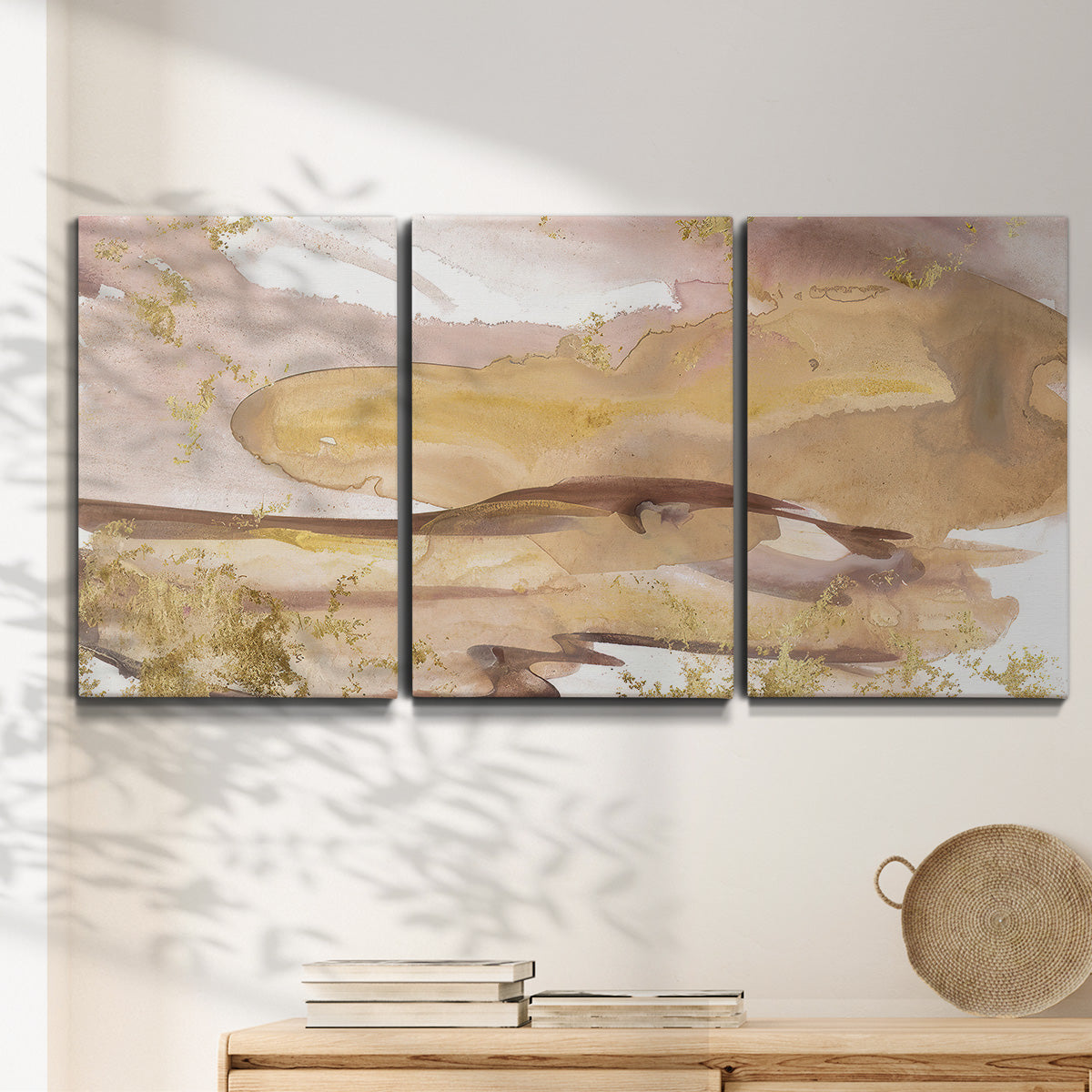 Three-panel canvas wall art featuring layered abstract dawn tones, displayed in a minimalist living room above a console table.