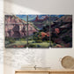 Three-panel canvas wall art featuring classic canyon landscape scene, displayed in a minimalist living room above a console table.