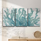Three-panel canvas wall art featuring blue coral inspired watercolor, displayed in a minimalist living room above a console table.
