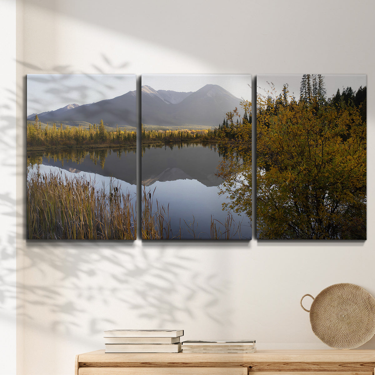 Three-panel canvas wall art featuring low light river photography, displayed in a minimalist living room above a console table.