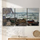 Three-panel canvas wall art featuring rough coastal seas under storm clouds, displayed in a minimalist living room above a console table.