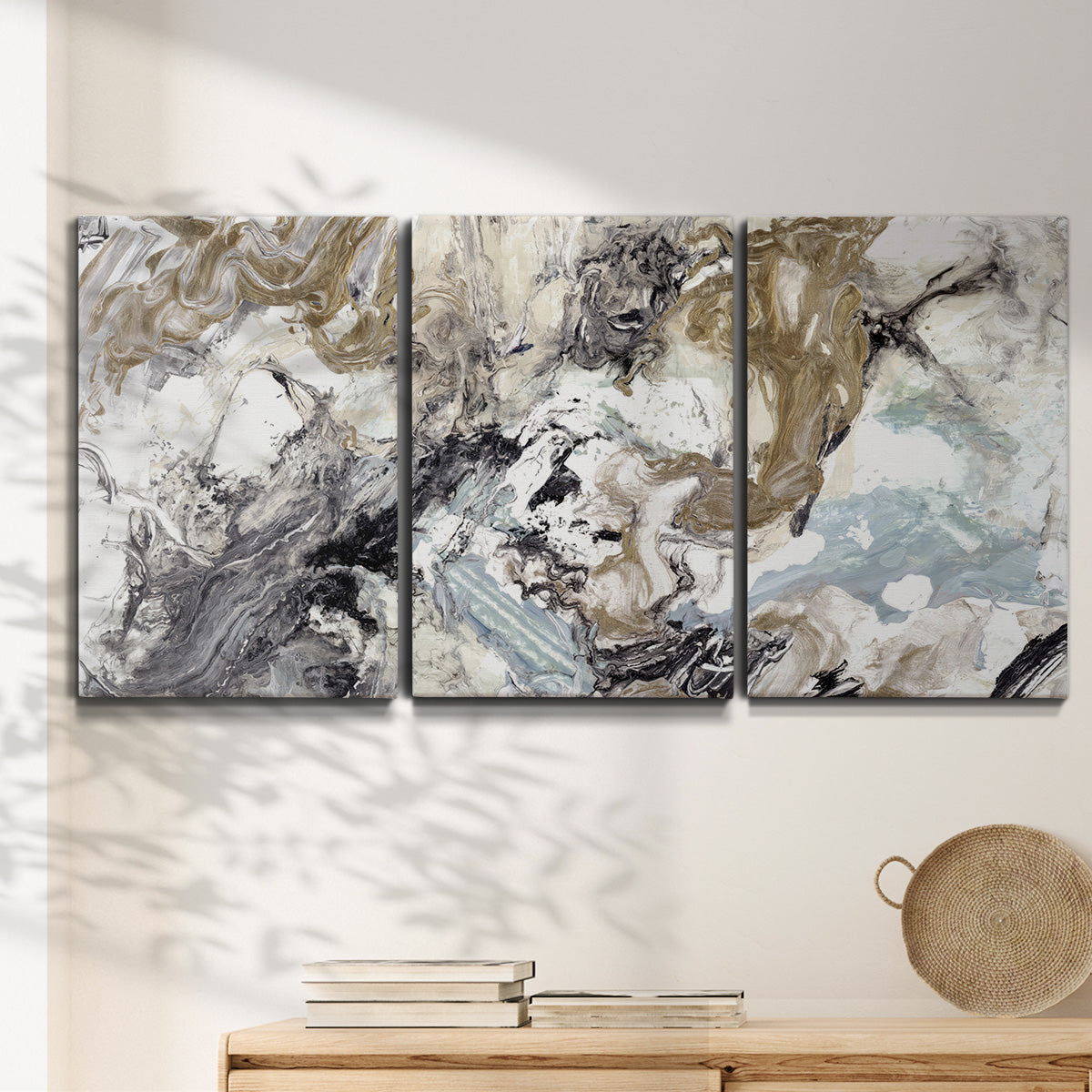 Three-panel canvas wall art featuring marbled modern abstract textures, displayed in a minimalist living room above a console table.