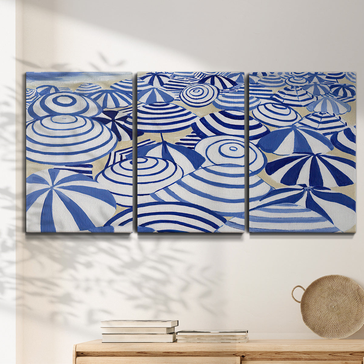 Three-panel canvas wall art featuring geometric abstract bowl forms, displayed in a minimalist living room above a console table.