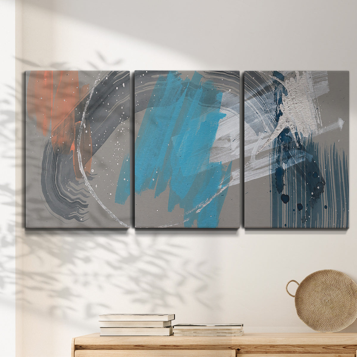 Three-panel canvas wall art featuring playful abstract mark making, displayed in a minimalist living room above a console table.