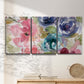 Three-panel canvas wall art featuring soft floral watercolor composition, displayed in a minimalist living room above a console table.