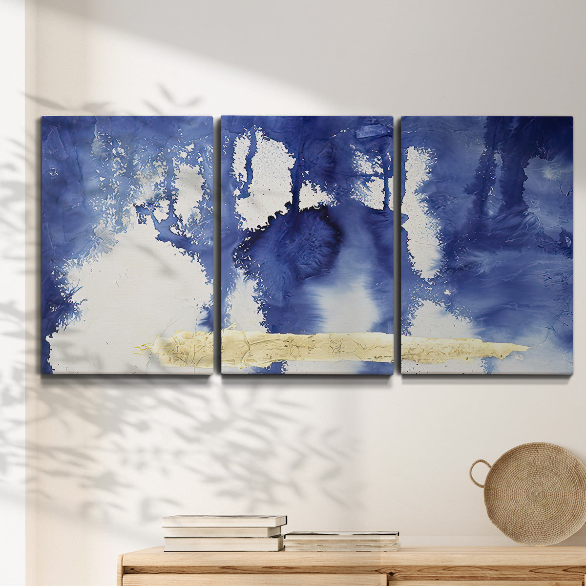 Three-panel canvas wall art featuring saturated abstract color fields, displayed in a minimalist living room above a console table.