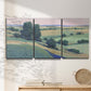 Three-panel canvas wall art featuring pastoral countryside with rocky outcrop, displayed in a minimalist living room above a console table.