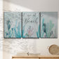 Three-panel canvas wall art featuring coastal typography with seahorses, displayed in a minimalist living room above a console table.
