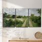 Three-panel canvas wall art featuring meadow trail through open grassland, displayed in a minimalist living room above a console table.