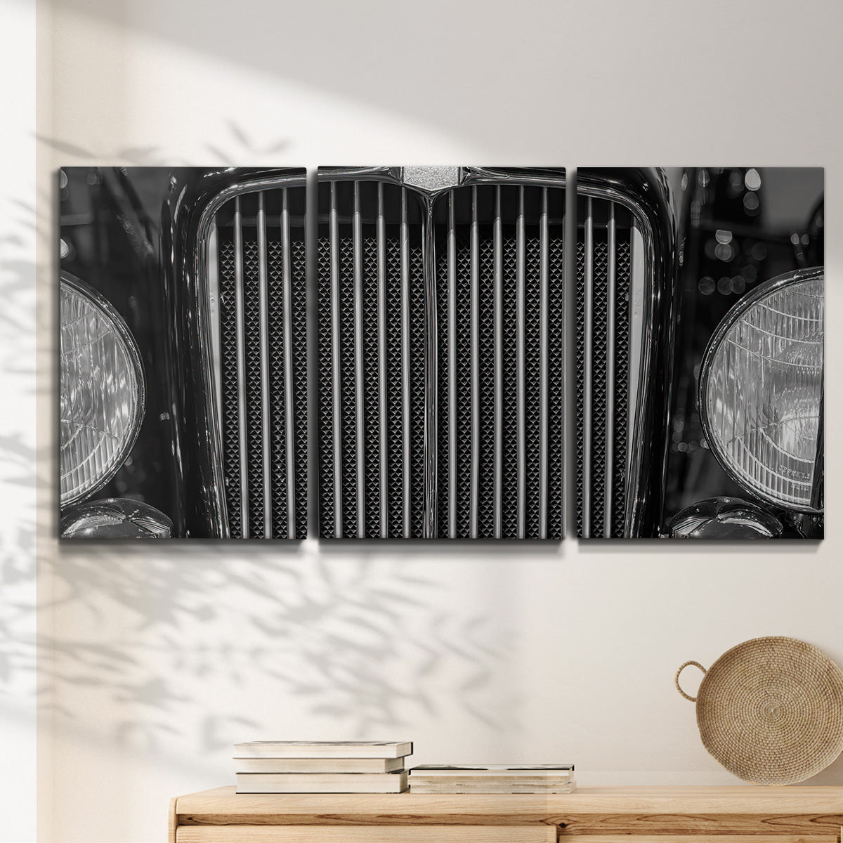 Three-panel canvas wall art featuring vintage car grille detail, displayed in a minimalist living room above a console table.