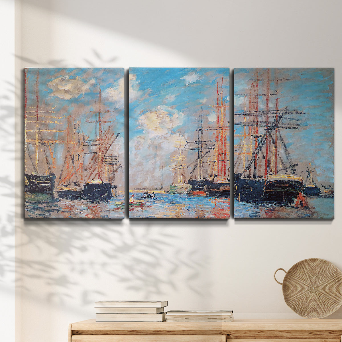 Three-panel canvas wall art featuring harbor with boats and water, displayed in a minimalist living room above a console table.