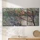 Three-panel canvas wall art featuring riverside park with figures and trees, displayed in a minimalist living room above a console table.