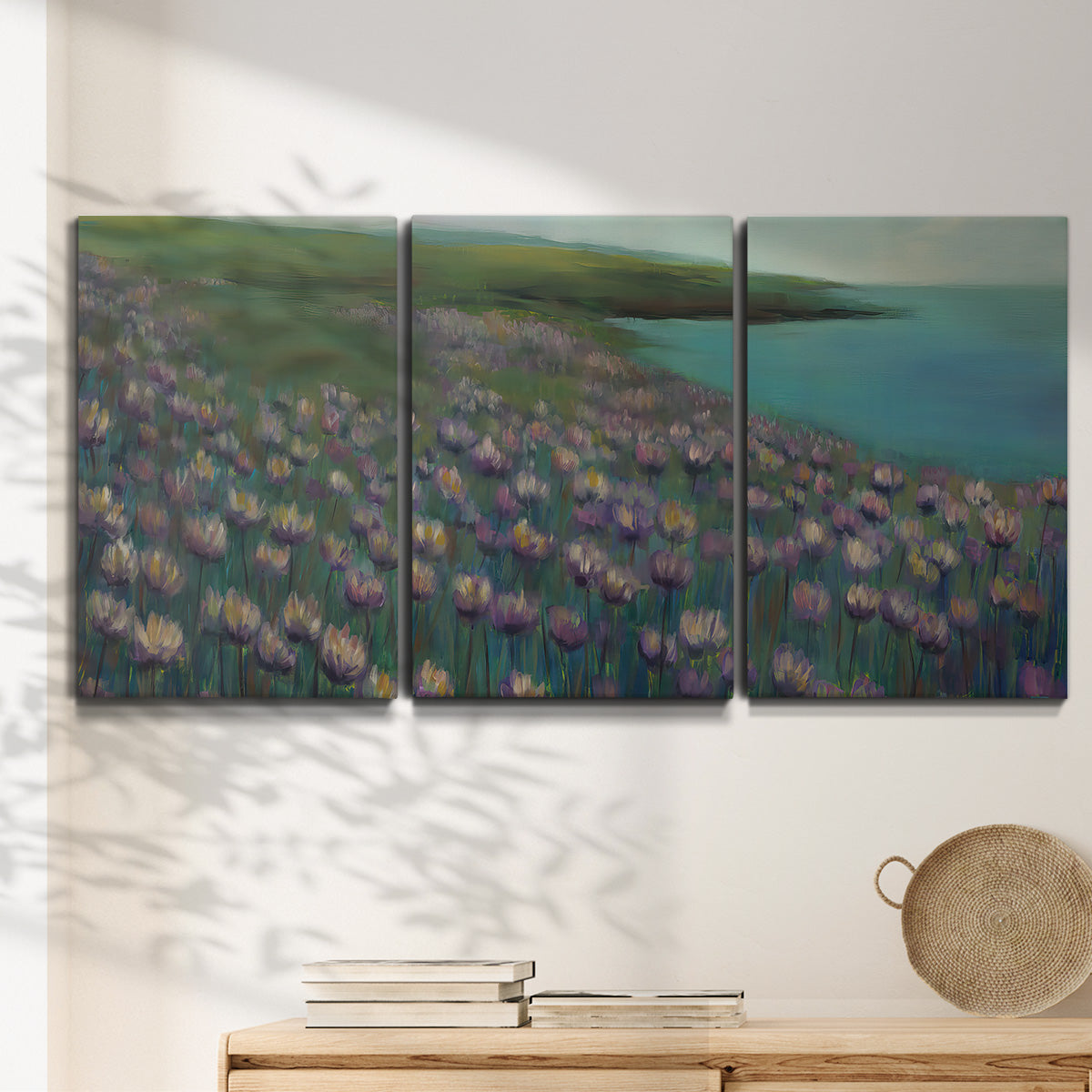 Three-panel canvas wall art featuring calm coastal landscape sanctuary, displayed in a minimalist living room above a console table.