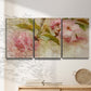 Three-panel canvas wall art featuring soft floral blossom composition, displayed in a minimalist living room above a console table.