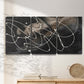 Three-panel canvas wall art featuring dark swirling abstract motion, displayed in a minimalist living room above a console table.