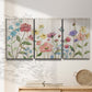 Three-panel canvas wall art featuring delicate wildflower illustration, displayed in a minimalist living room above a console table.