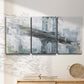 Three-panel canvas wall art featuring urban cityscape with architectural forms, displayed in a minimalist living room above a console table.