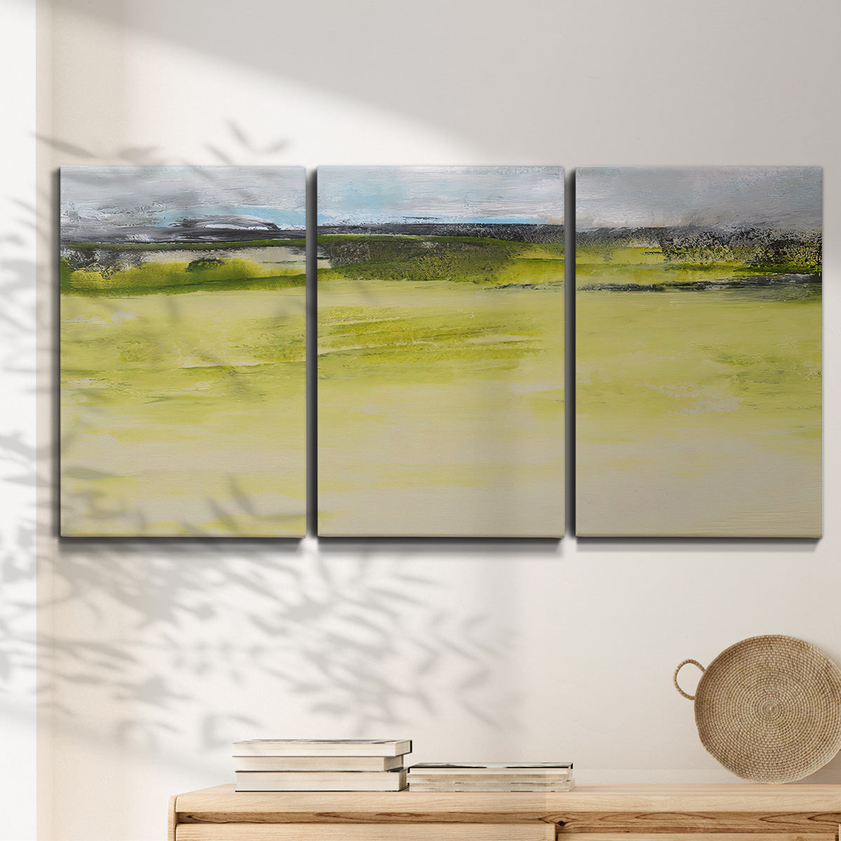 Three-panel canvas wall art featuring abstract terrace landscape view, displayed in a minimalist living room above a console table.