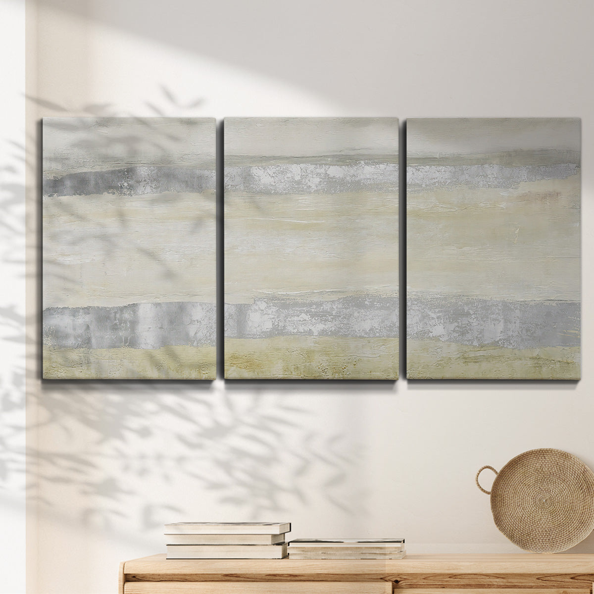 Three-panel canvas wall art featuring minimal abstract storm movement, displayed in a minimalist living room above a console table.