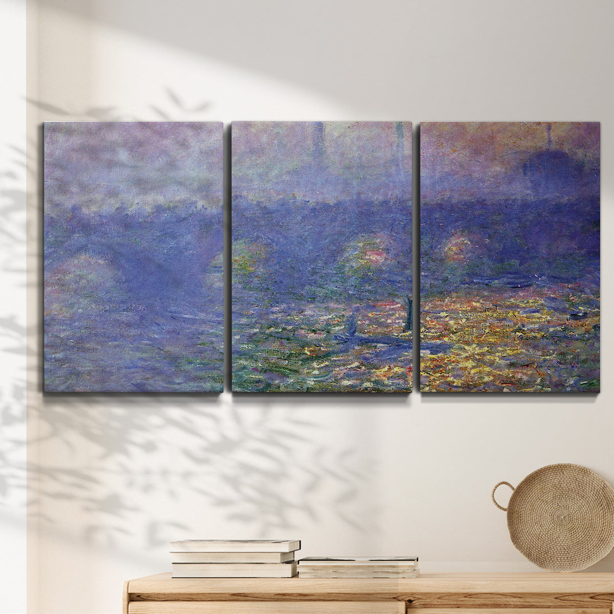Three-panel canvas wall art featuring overcast bridge above river, displayed in a minimalist living room above a console table.