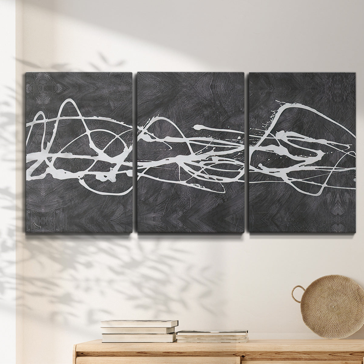 Three-panel canvas wall art featuring minimal abstract frequency lines, displayed in a minimalist living room above a console table.