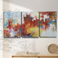 Three-panel canvas wall art featuring abstract city lights composition, displayed in a minimalist living room above a console table.
