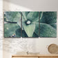 Three-panel canvas wall art featuring green succulent plant photograph, displayed in a minimalist living room above a console table.
