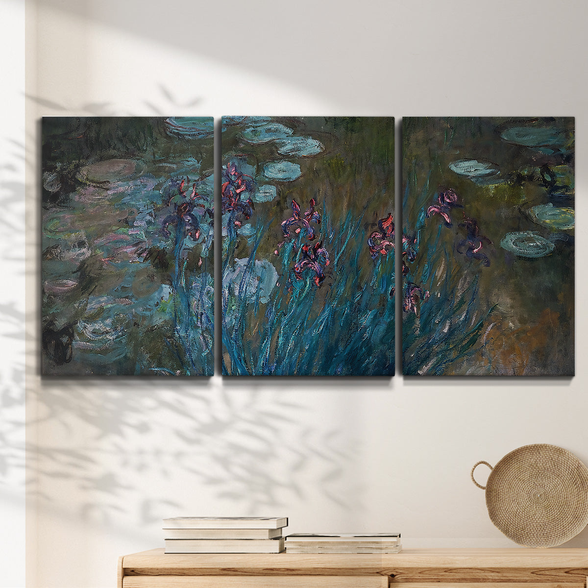 Three-panel canvas wall art featuring water lilies on reflective pond, displayed in a minimalist living room above a console table.