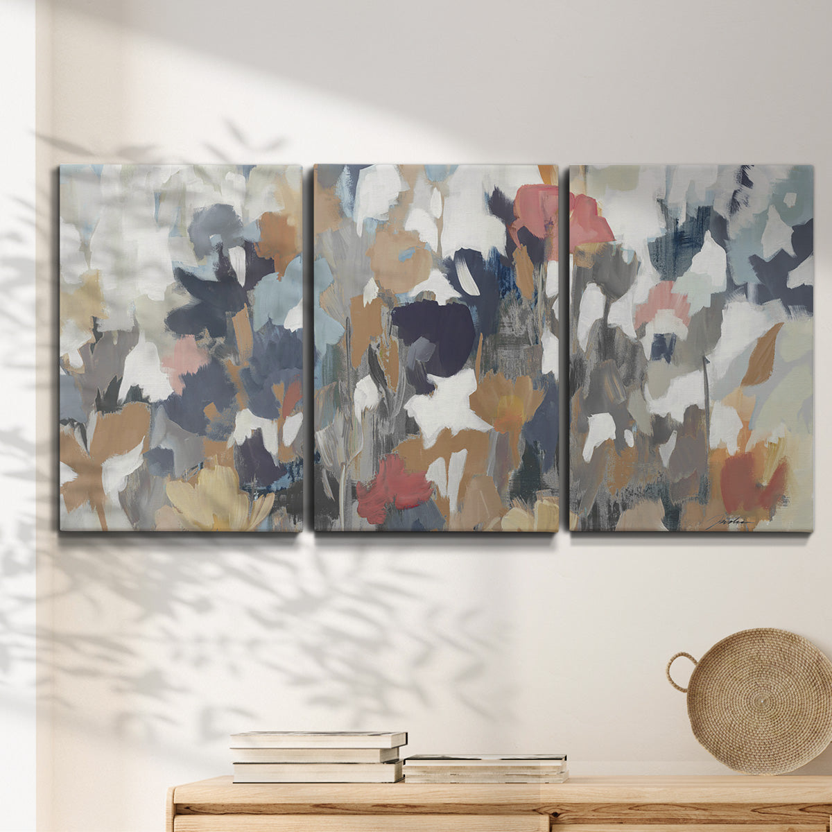 Three-panel canvas wall art featuring abstract flower stand composition, displayed in a minimalist living room above a console table.