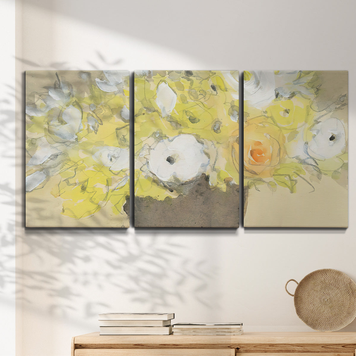 Three-panel canvas wall art featuring abstract floral table arrangement, displayed in a minimalist living room above a console table.