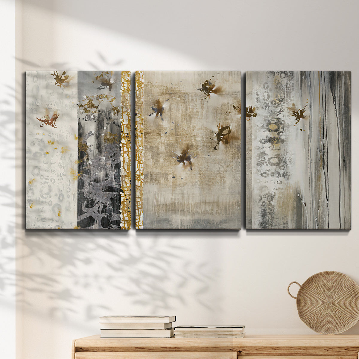 Three-panel canvas wall art featuring abstract willow inspired vertical forms, displayed in a minimalist living room above a console table.