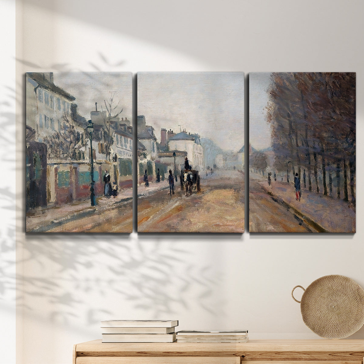 Three-panel canvas wall art featuring tree lined boulevard in town, displayed in a minimalist living room above a console table.