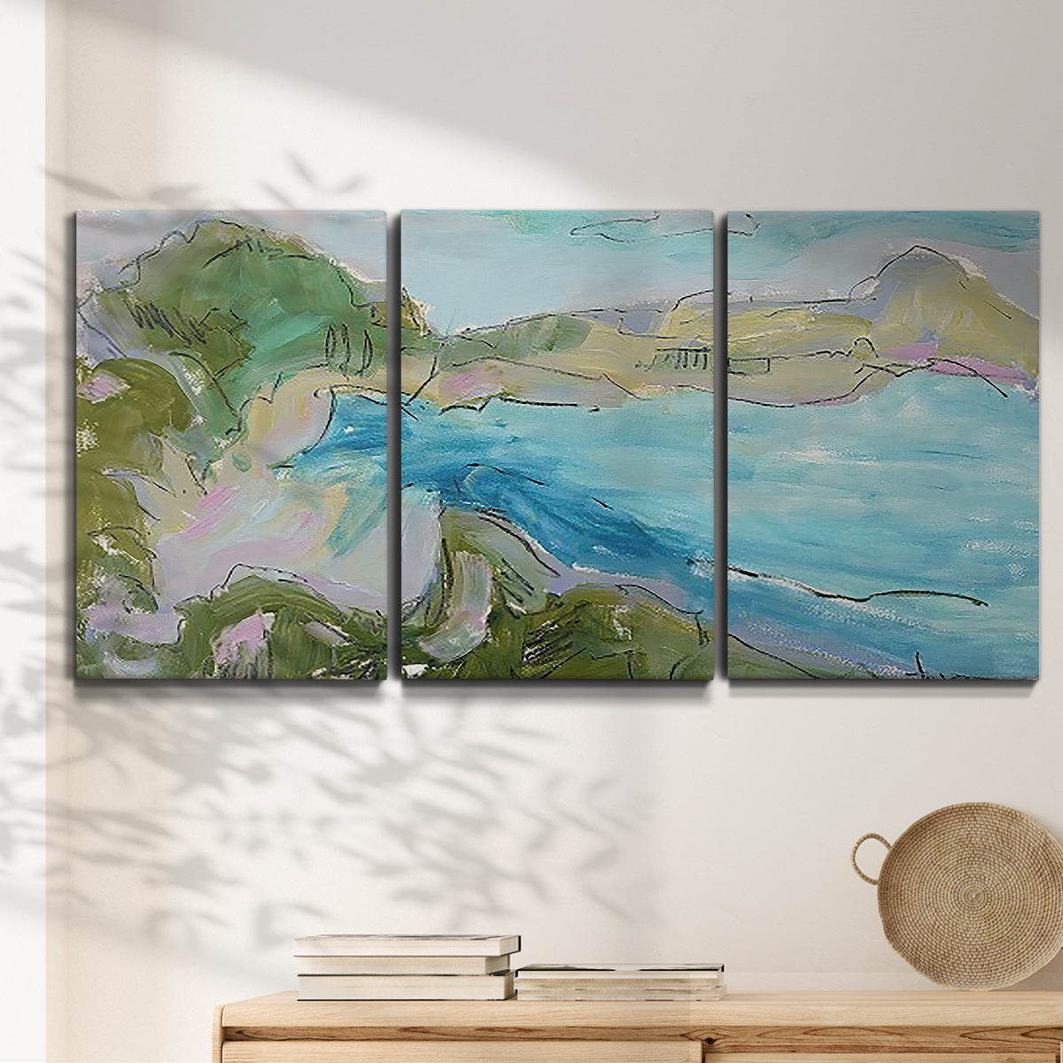 Three-panel canvas wall art featuring open landscape with landing strip, displayed in a minimalist living room above a console table.