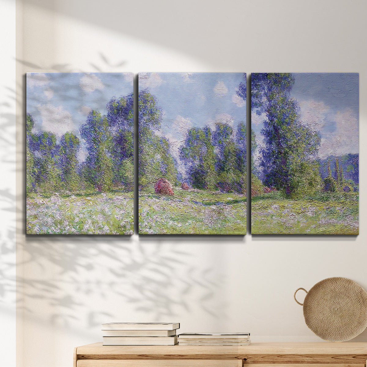 Three-panel canvas wall art featuring poppy field near garden village, displayed in a minimalist living room above a console table.