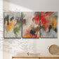 Three-panel canvas wall art featuring abstract floral color composition, displayed in a minimalist living room above a console table.