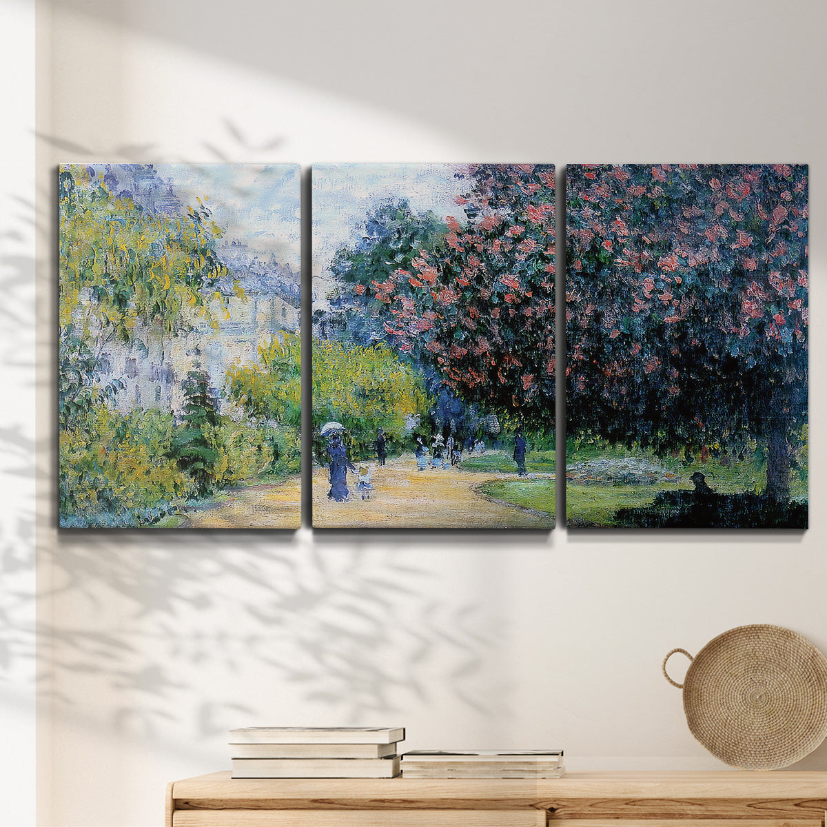 Three-panel canvas wall art featuring formal city park with trees, displayed in a minimalist living room above a console table.