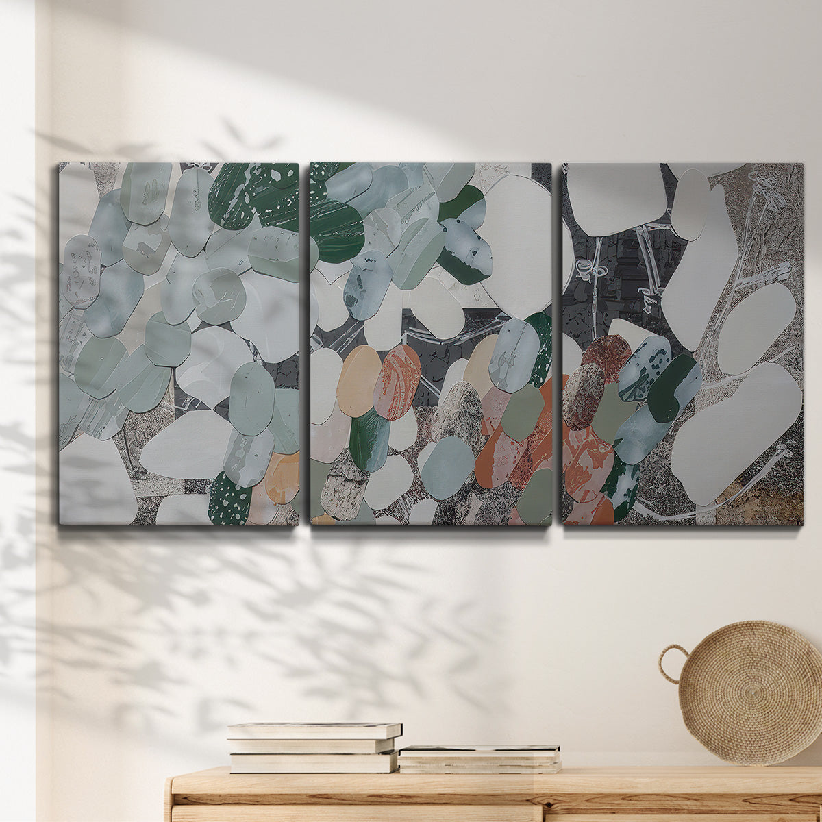 Three-panel canvas wall art featuring layered canyon inspired abstract forms, displayed in a minimalist living room above a console table.