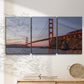 Three-panel canvas wall art featuring golden gate bridge spanning bay, displayed in a minimalist living room above a console table.