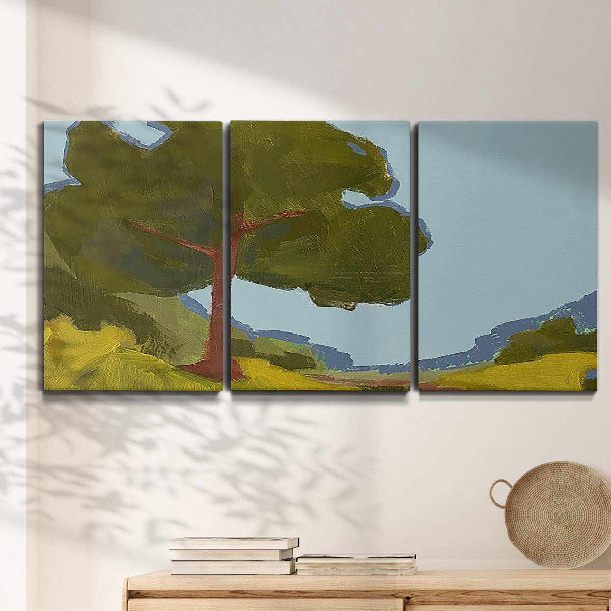 Three-panel canvas wall art featuring sunlit public park landscape view, displayed in a minimalist living room above a console table.
