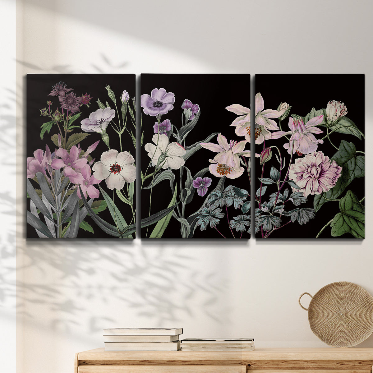 Three-panel canvas wall art featuring early spring blossoms in soft tones, displayed in a minimalist living room above a console table.