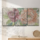 Three-panel canvas wall art featuring pastel peony flower composition, displayed in a minimalist living room above a console table.