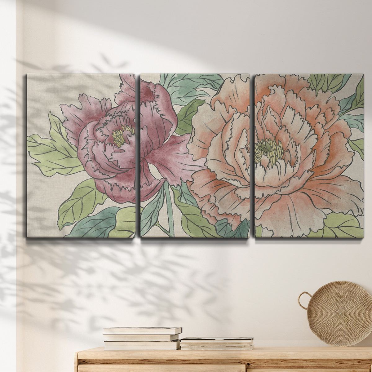 Three-panel canvas wall art featuring pastel peony flower composition, displayed in a minimalist living room above a console table.