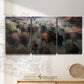Three-panel canvas wall art featuring stormy canyon landscape with animals, displayed in a minimalist living room above a console table.