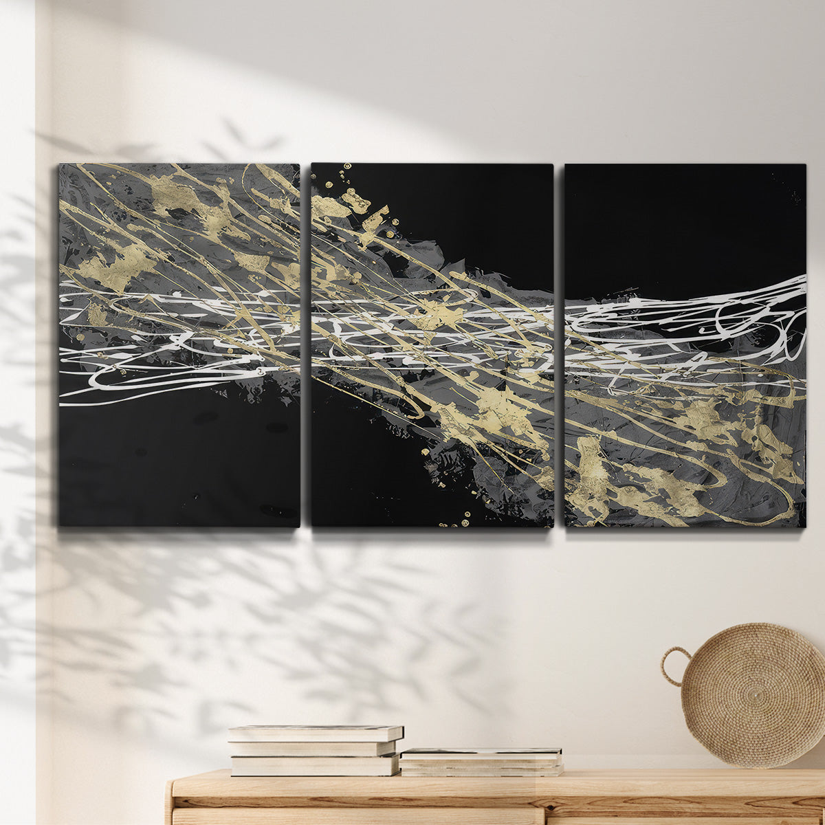Three-panel canvas wall art featuring dark modern abstract wind patterns, displayed in a minimalist living room above a console table.