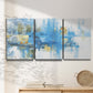 Three-panel canvas wall art featuring blue toned abstract city rhythm, displayed in a minimalist living room above a console table.