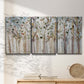Three-panel canvas wall art featuring bare birch trees in winter forest, displayed in a minimalist living room above a console table.