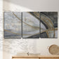 Three-panel canvas wall art featuring spiraling abstract vortex motion, displayed in a minimalist living room above a console table.